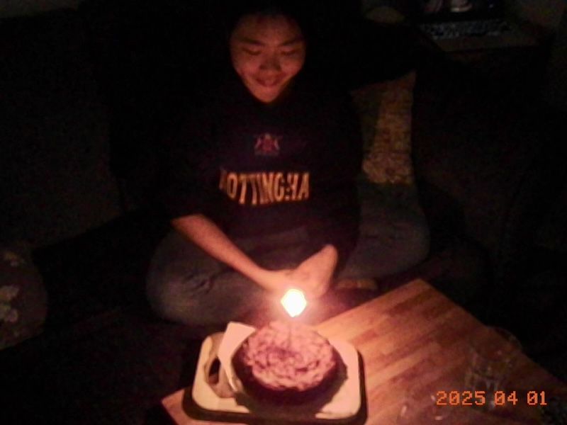 Me leaning over a birthday cake lit with candles.